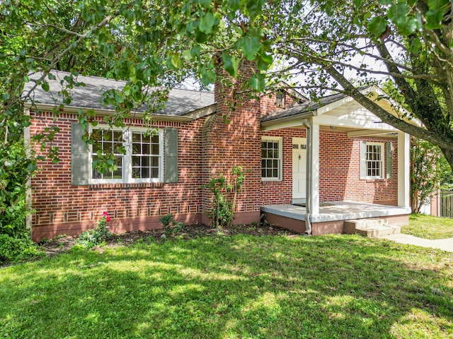 1204 Rolling Fields Dr, Columbia, TN 38401 - view of front of house featuring a front yard, brick siding, and a chimney