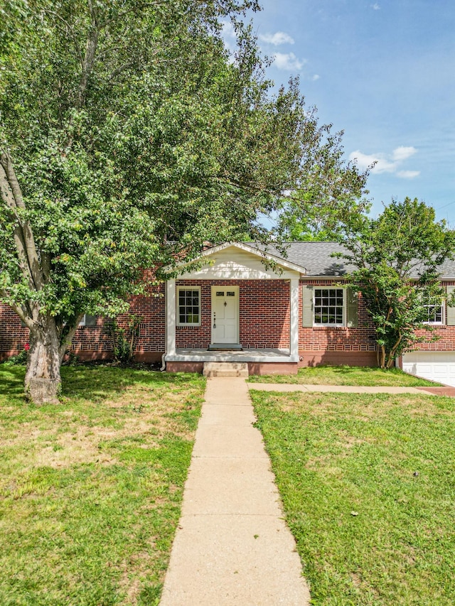 1204 Rolling Fields Dr, Columbia, TN 38401 - view of front facade with brick siding and a front lawn