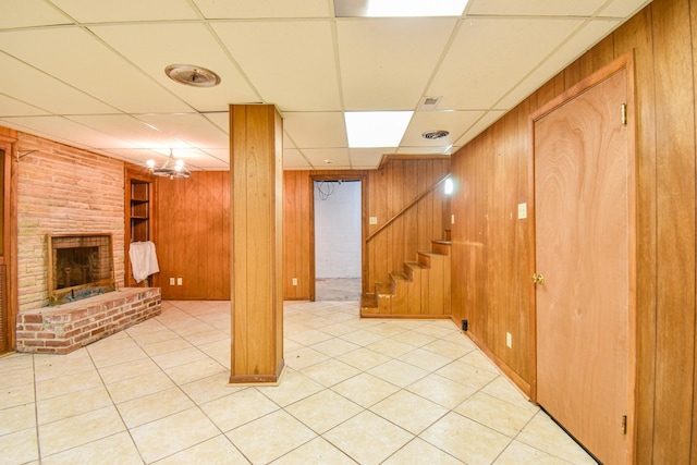 1204 Rolling Fields Dr, Columbia, TN 38401 - finished below grade area featuring wooden walls, a drop ceiling, a fireplace, stairs, and light tile patterned floors