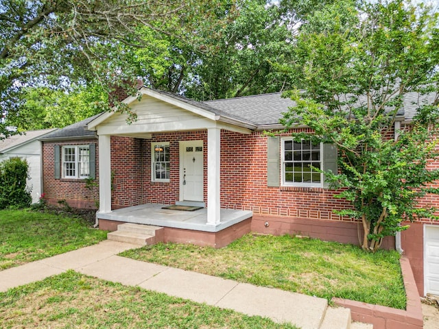 1204 Rolling Fields Dr, Columbia, TN 38401 - view of front facade featuring brick siding, a front lawn, a shingled roof, and covered porch