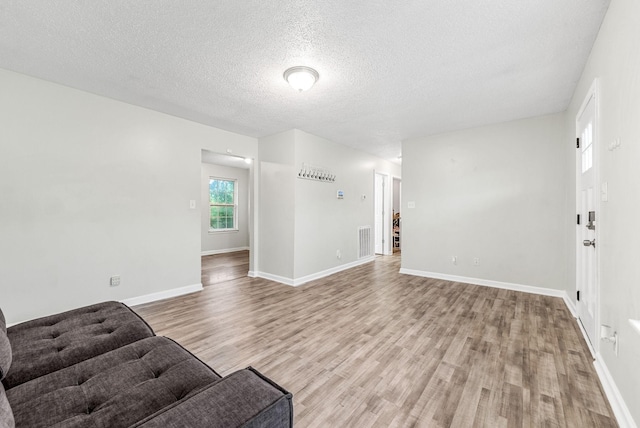 408 Eddy St, Oak Grove, KY 42262 - unfurnished living room with light wood-style floors and a textured ceiling