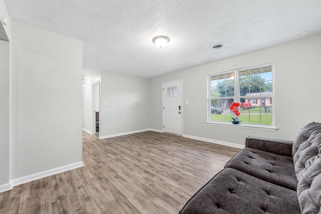 408 Eddy St, Oak Grove, KY 42262 - living area with wood finished floors and a textured ceiling