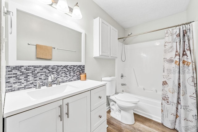 408 Eddy St, Oak Grove, KY 42262 - bathroom with wood finished floors, shower / tub combo with curtain, vanity, backsplash, and a textured ceiling