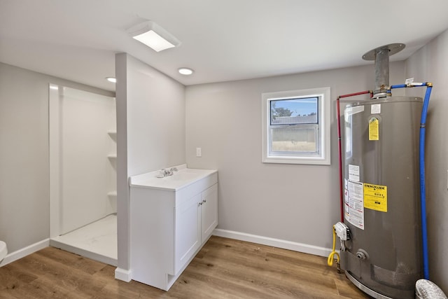 102 Hodges St N, Cowan, TN 37318 - full bathroom featuring gas water heater, wood finished floors, a stall shower, and vanity