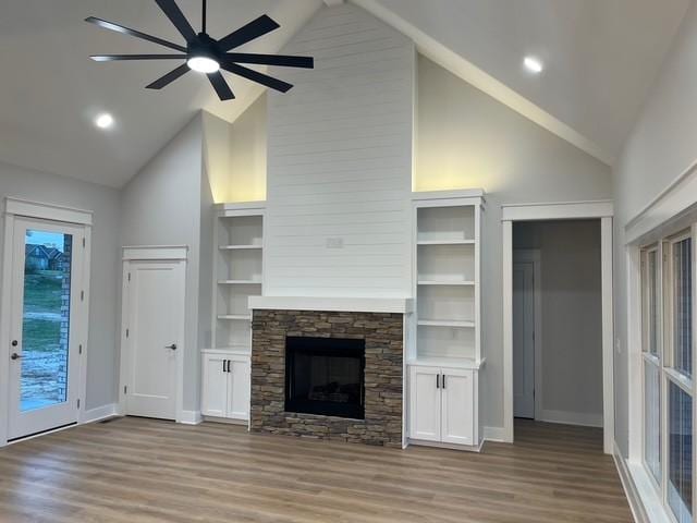 8246 Aedc Rd, Estill Springs, TN 37330 - unfurnished living room featuring high vaulted ceiling, light wood-style flooring, a ceiling fan, a fireplace, and recessed lighting