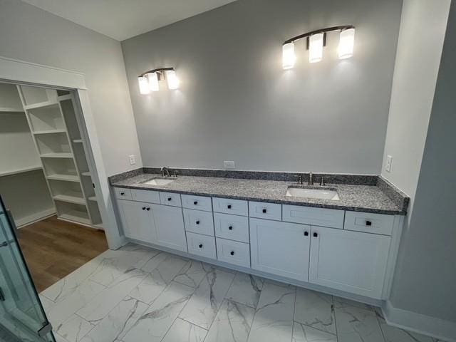 8246 Aedc Rd, Estill Springs, TN 37330 - bathroom featuring marble finish floors, double vanity, and a spacious closet