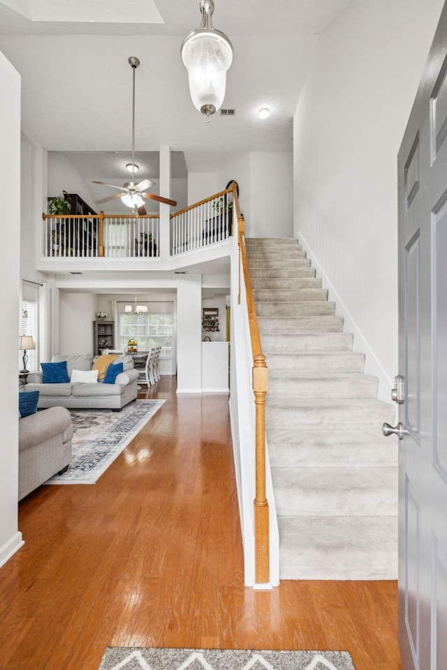 1443 Bern Dr, Spring Hill, TN 37174 - stairs with wood finished floors, ceiling fan, and a high ceiling