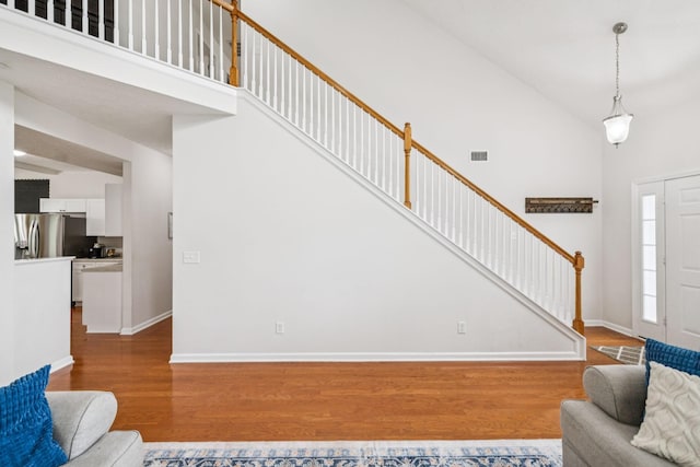 1443 Bern Dr, Spring Hill, TN 37174 - living room featuring high vaulted ceiling, wood finished floors, and stairway