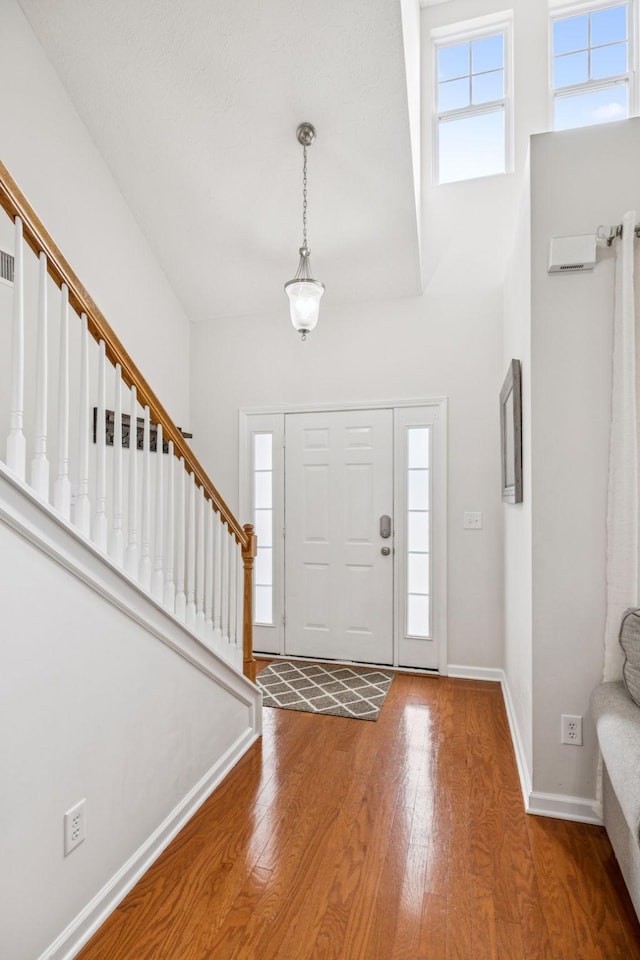 1443 Bern Dr, Spring Hill, TN 37174 - entrance foyer featuring wood finished floors, stairway, and a high ceiling