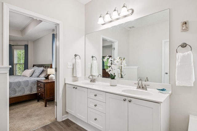 1443 Bern Dr, Spring Hill, TN 37174 - ensuite bathroom featuring double vanity, wood finished floors, and a tray ceiling
