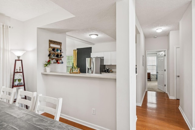 1443 Bern Dr, Spring Hill, TN 37174 - dining space featuring a textured ceiling and wood finished floors
