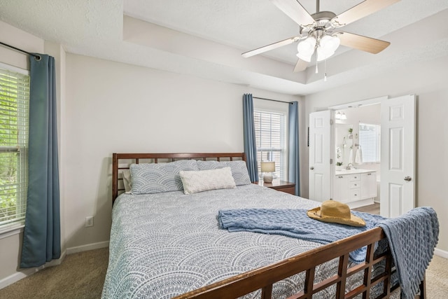 1443 Bern Dr, Spring Hill, TN 37174 - carpeted bedroom featuring a raised ceiling, ensuite bath, and a ceiling fan