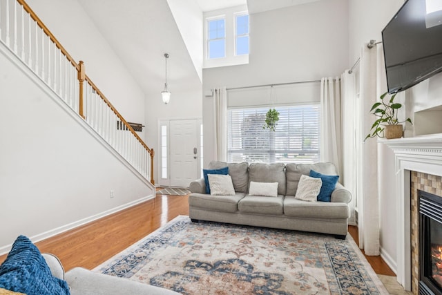 1443 Bern Dr, Spring Hill, TN 37174 - living room with wood finished floors, a towering ceiling, a fireplace, and stairway