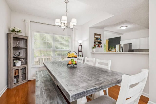 1443 Bern Dr, Spring Hill, TN 37174 - dining area with a chandelier, a textured ceiling, and wood finished floors