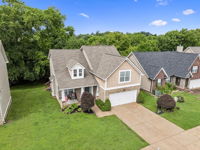 1443 Bern Dr, Spring Hill, TN 37174 - view of front of house with driveway, stone siding, an attached garage, and a front lawn