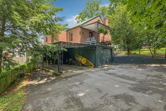 1338 Ardee Ave, Nashville, TN 37216 - back of property with asphalt driveway, brick siding, a chimney, and an attached garage