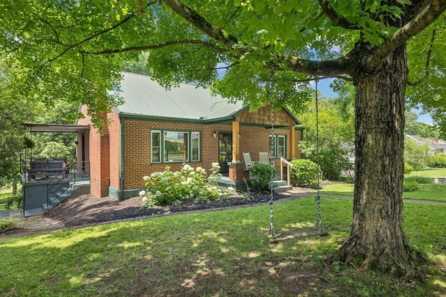1338 Ardee Ave, Nashville, TN 37216 - view of front of home with brick siding, a front lawn, covered porch, and a metal roof