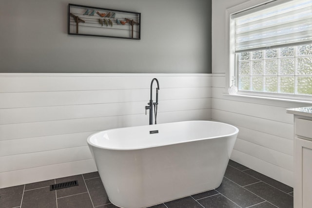5077 Joe Peay Rd, Spring Hill, TN 37174 - full bathroom featuring wainscoting, a freestanding tub, tile patterned floors, and vanity