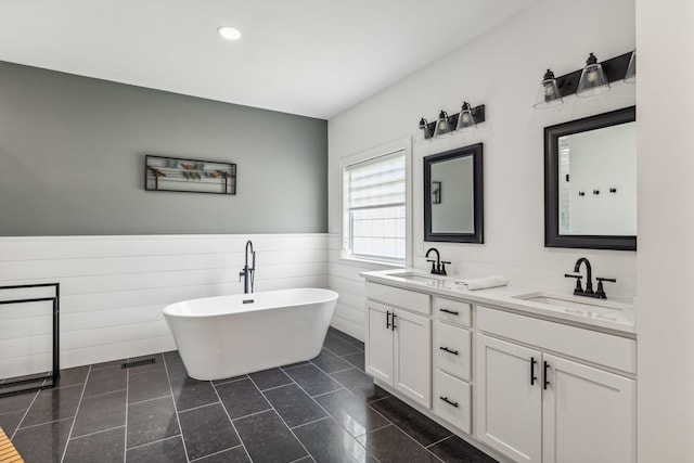 5077 Joe Peay Rd, Spring Hill, TN 37174 - bathroom featuring double vanity, a wainscoted wall, a soaking tub, and recessed lighting