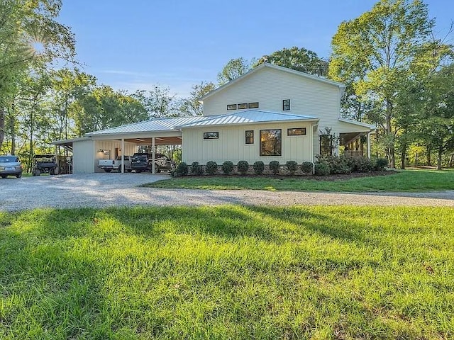 2001 Trilogy Ln, Mount Pleasant, TN 38474 - view of front of property featuring driveway, a carport, a front yard, a metal roof, and a standing seam roof