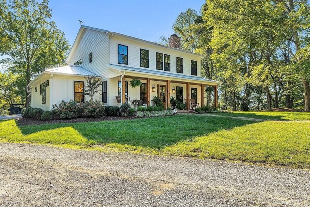 2001 Trilogy Ln, Mount Pleasant, TN 38474 - view of front of house with a chimney, a porch, and a front lawn