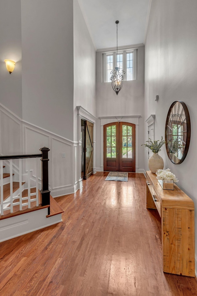 1051 Fitzroy Cir, Spring Hill, TN 37174 - foyer entrance featuring ornamental molding, a chandelier, plenty of natural light, french doors, and wood finished floors