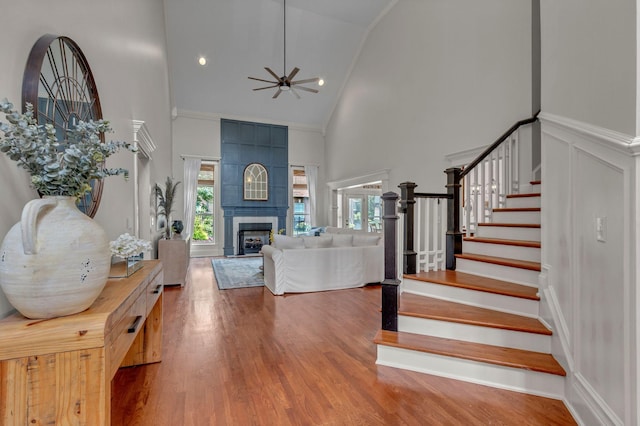 1051 Fitzroy Cir, Spring Hill, TN 37174 - entrance foyer featuring high vaulted ceiling, ceiling fan, stairway, a tile fireplace, and wood finished floors