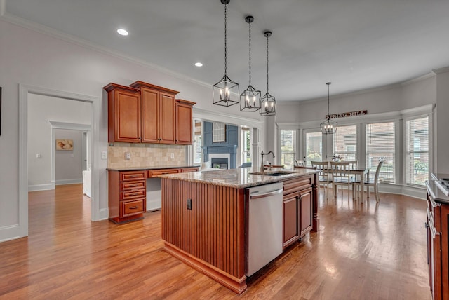 1051 Fitzroy Cir, Spring Hill, TN 37174 - kitchen featuring stainless steel dishwasher, brown cabinetry, decorative backsplash, light wood-type flooring, and a center island with sink