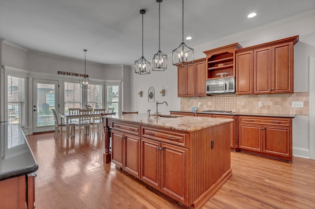 1051 Fitzroy Cir, Spring Hill, TN 37174 - kitchen featuring appliances with stainless steel finishes, open shelves, backsplash, light wood finished floors, and brown cabinetry
