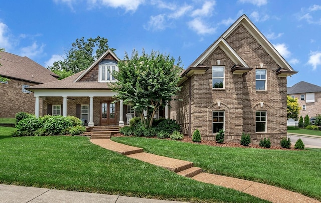 1051 Fitzroy Cir, Spring Hill, TN 37174 - craftsman-style home with brick siding, a front yard, and covered porch
