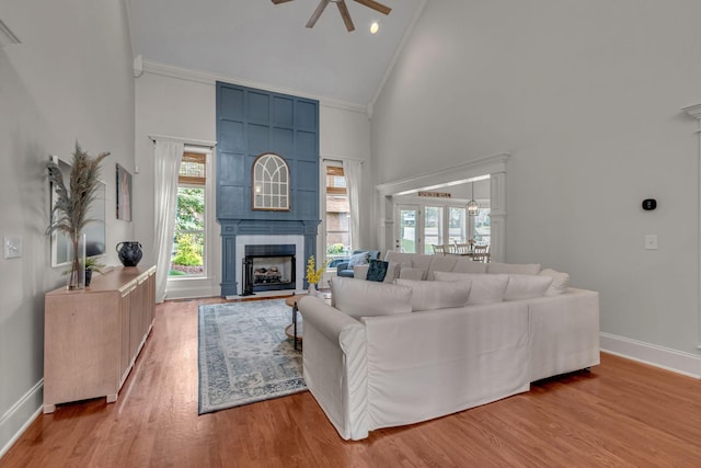 1051 Fitzroy Cir, Spring Hill, TN 37174 - living room with high vaulted ceiling, ceiling fan, a fireplace, wood finished floors, and crown molding