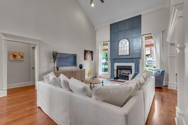 1051 Fitzroy Cir, Spring Hill, TN 37174 - living area featuring high vaulted ceiling, crown molding, a fireplace, light wood-style flooring, and a ceiling fan