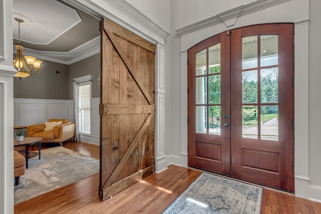 1051 Fitzroy Cir, Spring Hill, TN 37174 - entrance foyer featuring a decorative wall, wood finished floors, french doors, a wainscoted wall, and ornamental molding