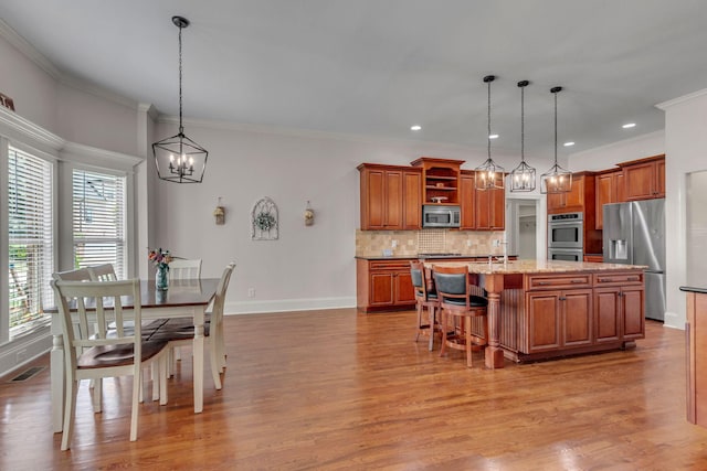1051 Fitzroy Cir, Spring Hill, TN 37174 - kitchen with stainless steel appliances, open shelves, brown cabinets, tasteful backsplash, and a chandelier