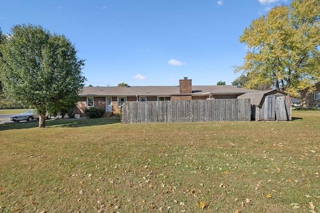 519 Hemingway Dr, Columbia, TN 38401 - rear view of property featuring a shed, a chimney, and brick siding