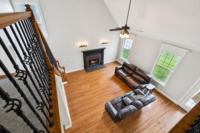 3002 Stow Xing, Murfreesboro, TN 37128 - living area featuring healthy amount of natural light, a tiled fireplace, wood finished floors, a ceiling fan, and high vaulted ceiling