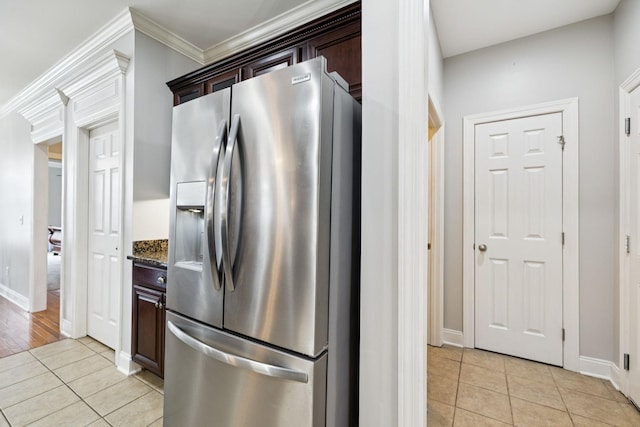 3002 Stow Xing, Murfreesboro, TN 37128 - kitchen featuring stainless steel refrigerator with ice dispenser, light tile patterned flooring, dark stone counters, dark brown cabinets, and ornamental molding