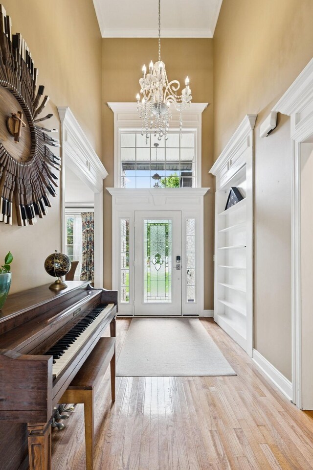 3002 Stow Xing, Murfreesboro, TN 37128 - entrance foyer with a high ceiling, a chandelier, wood finished floors, and crown molding