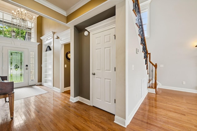 3002 Stow Xing, Murfreesboro, TN 37128 - foyer featuring stairs, crown molding, hardwood / wood-style floors, and a chandelier