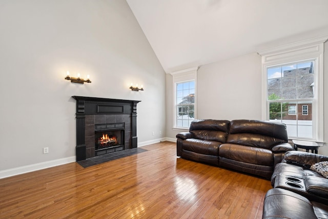 3002 Stow Xing, Murfreesboro, TN 37128 - living room featuring healthy amount of natural light, wood finished floors, a tile fireplace, and high vaulted ceiling