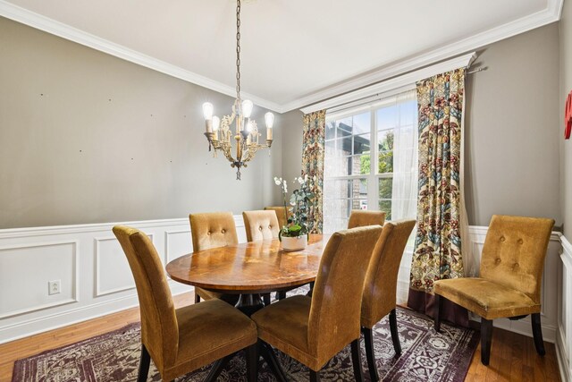 3002 Stow Xing, Murfreesboro, TN 37128 - dining room with light wood-style flooring, ornamental molding, a chandelier, wainscoting, and a decorative wall