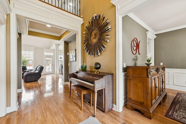 3002 Stow Xing, Murfreesboro, TN 37128 - corridor with ornate columns, light wood-style flooring, crown molding, and a wainscoted wall