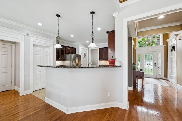 3002 Stow Xing, Murfreesboro, TN 37128 - kitchen with stainless steel refrigerator with ice dispenser, light wood-type flooring, dark brown cabinetry, dark stone counters, and recessed lighting