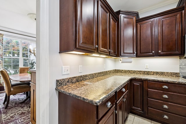 3002 Stow Xing, Murfreesboro, TN 37128 - kitchen featuring dark brown cabinetry, ornamental molding, and stone counters