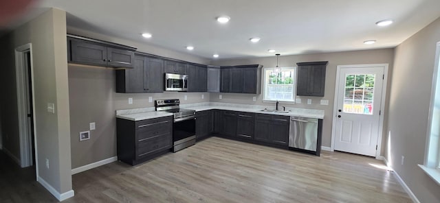 1323 Higginbotham Rd, Mcminnville, TN 37110 - kitchen featuring appliances with stainless steel finishes, light wood-type flooring, light countertops, recessed lighting, and pendant lighting