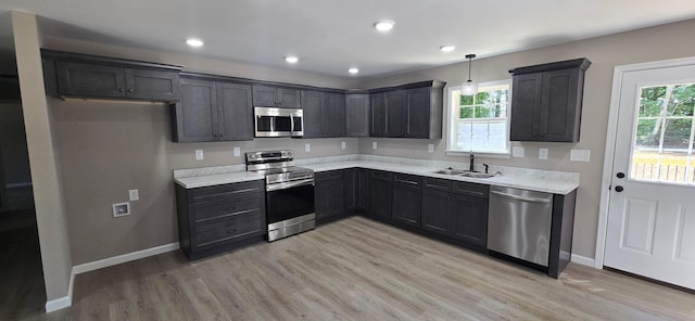 1323 Higginbotham Rd, Mcminnville, TN 37110 - kitchen featuring appliances with stainless steel finishes, light wood finished floors, plenty of natural light, light countertops, and recessed lighting