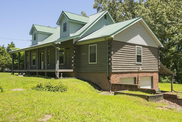 1530 Roy Brown Rd, Burns, TN 37029 - view of home's exterior with a porch, log exterior, a yard, a garage, and a metal roof