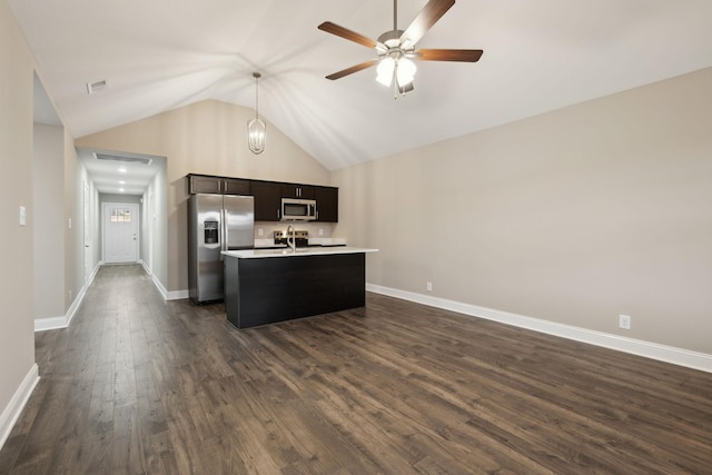 130 Alabama Ave, Oak Grove, KY 42262 - kitchen featuring appliances with stainless steel finishes, light countertops, lofted ceiling, a kitchen island with sink, and dark wood finished floors