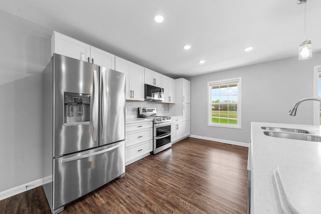 369 Springwater Dr, Summertown, TN 38483 - kitchen with appliances with stainless steel finishes, light countertops, dark wood-type flooring, white cabinets, and recessed lighting