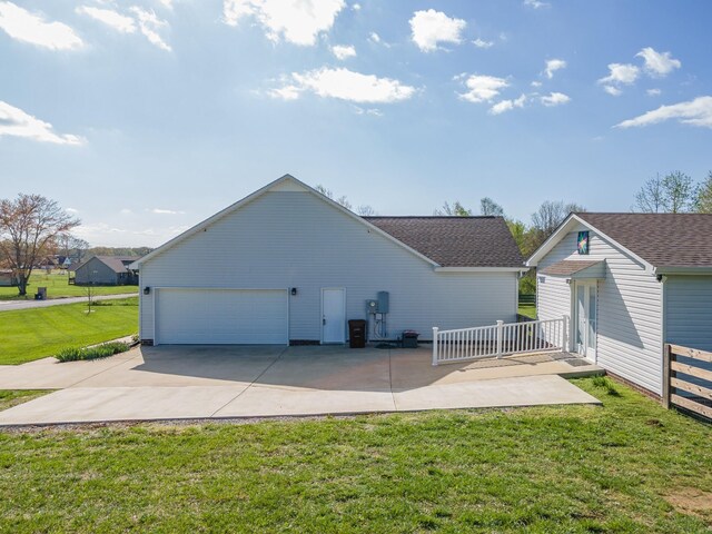 369 Springwater Dr, Summertown, TN 38483 - rear view of property featuring a yard, an outbuilding, roof with shingles, and concrete driveway